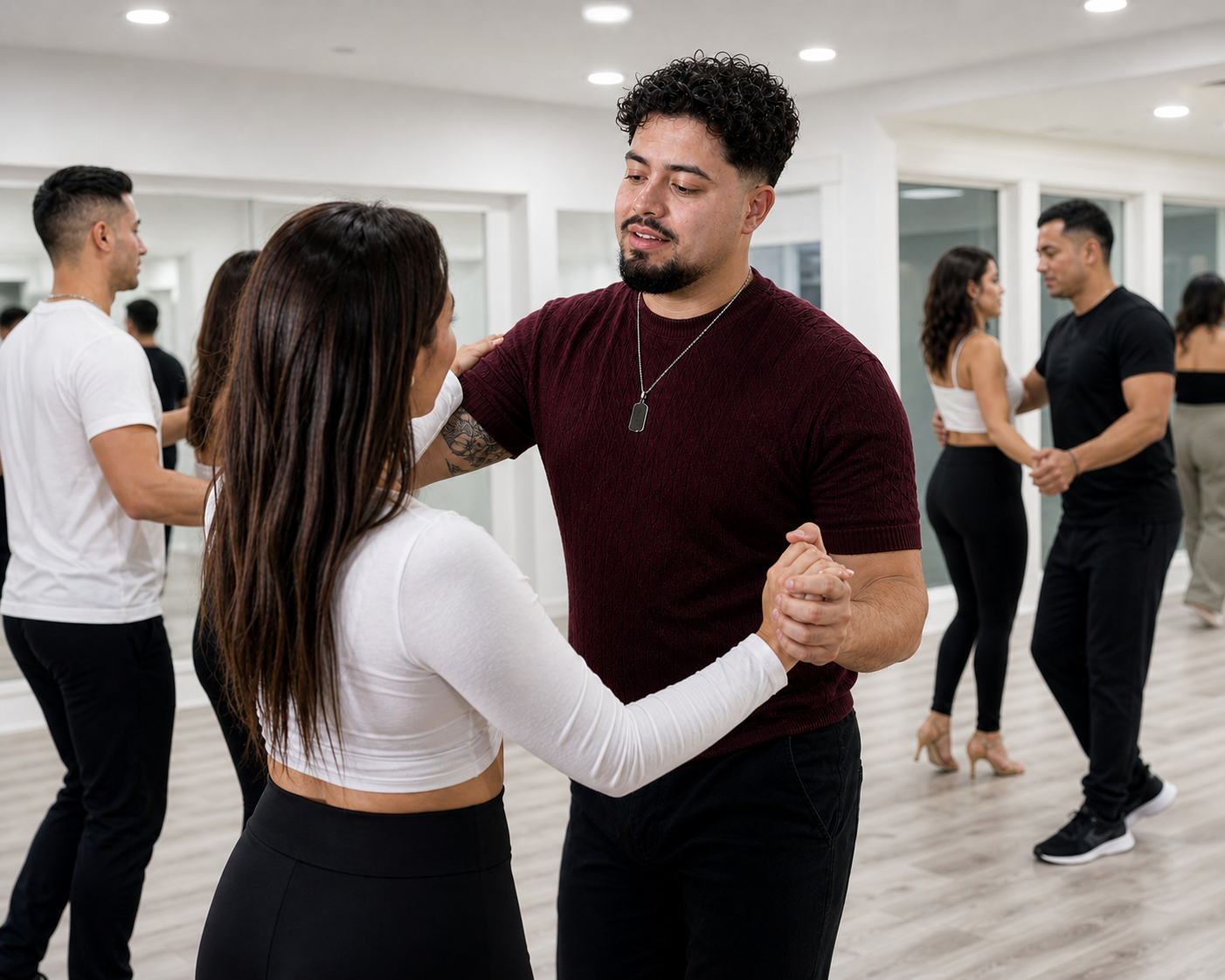 Junior coaching Bachata partnerwork in a bright white studio.